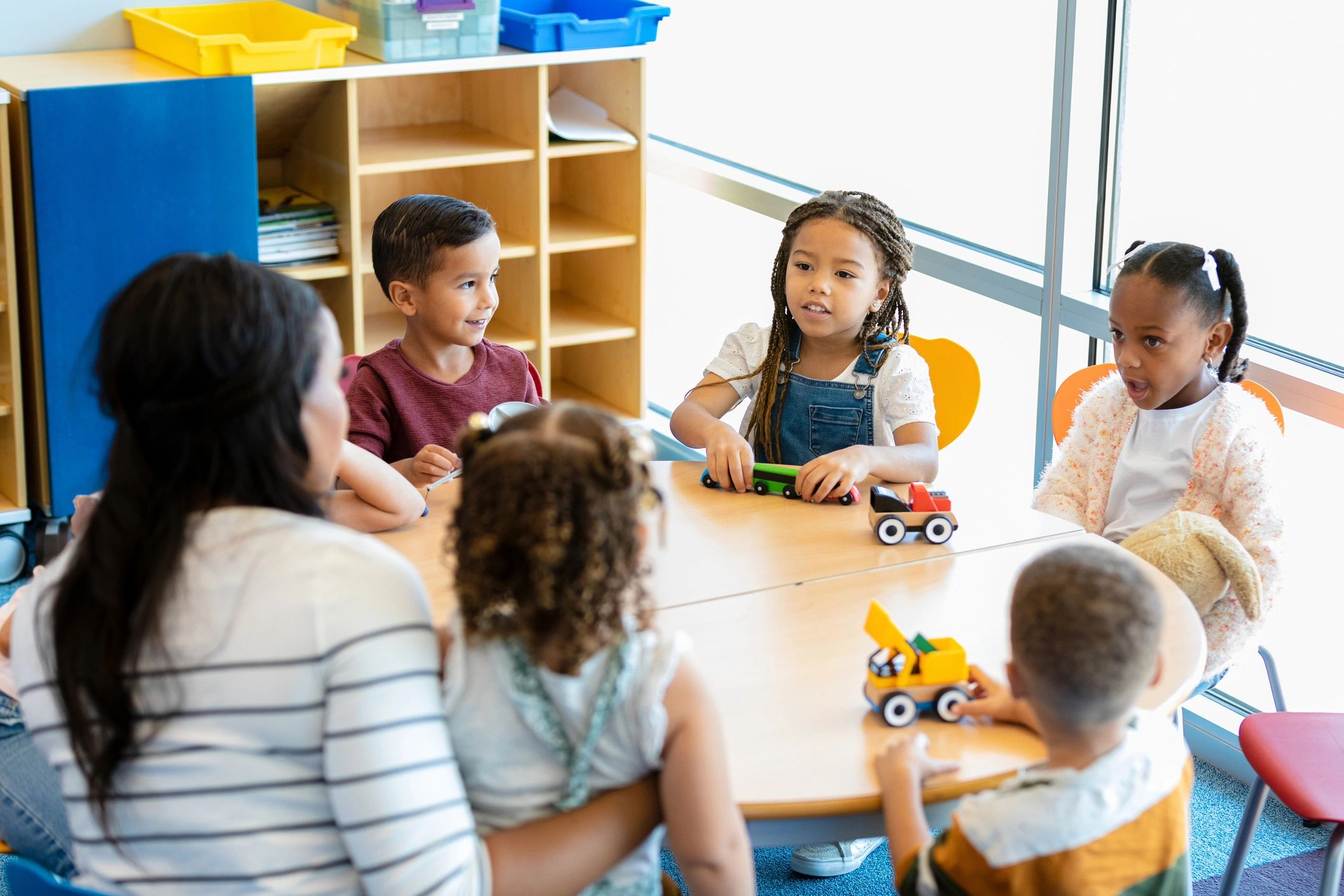 Preschool children learning with a teacher in a classroom