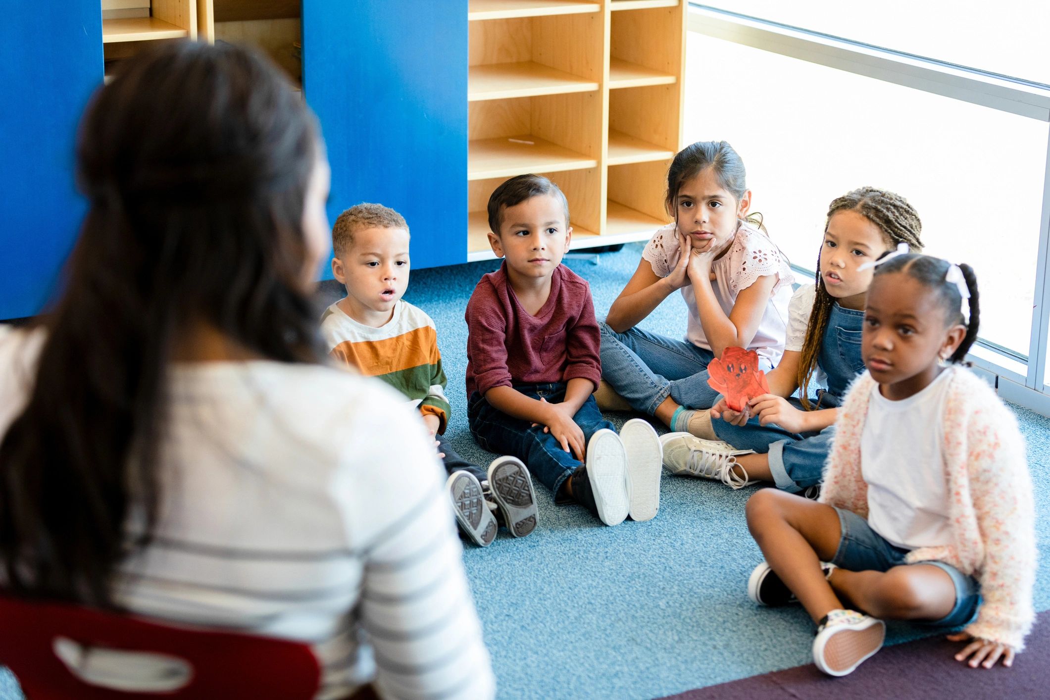 Teacher reading to children during circle time