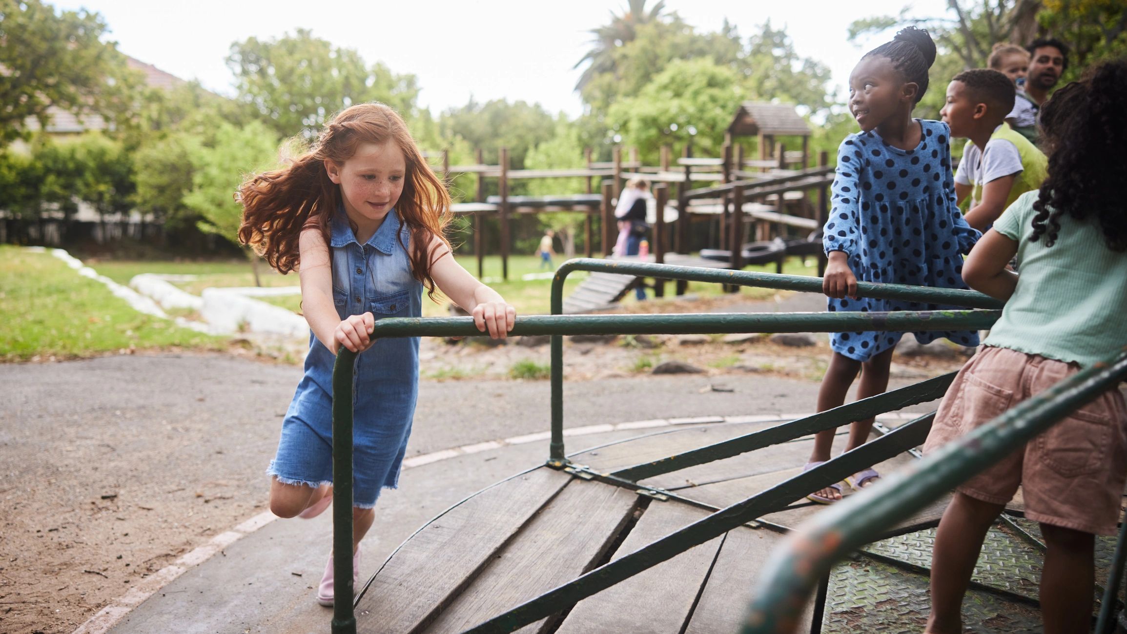 Children playing on a merry-go-round in a park