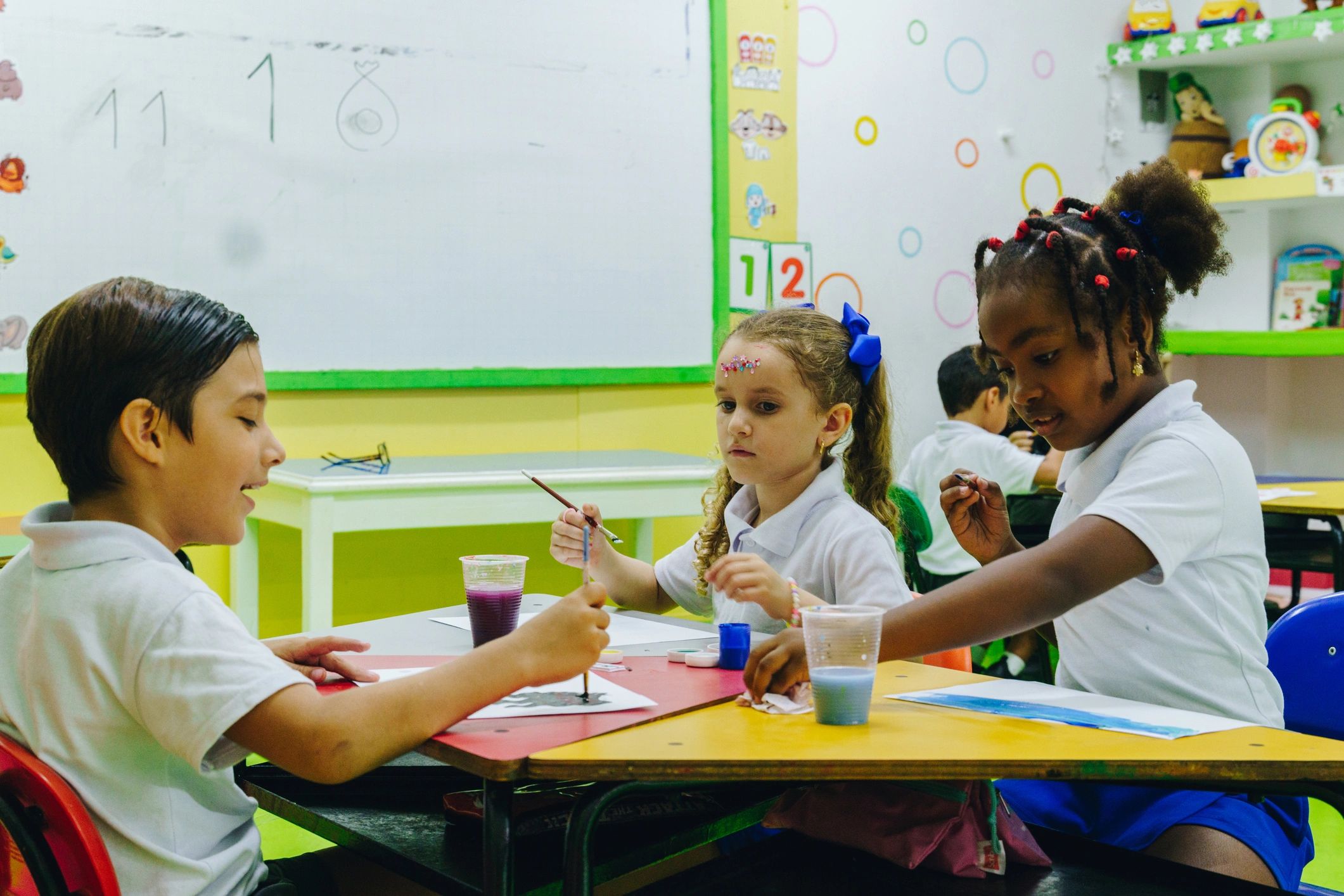 Children painting and drawing together in an art activity
