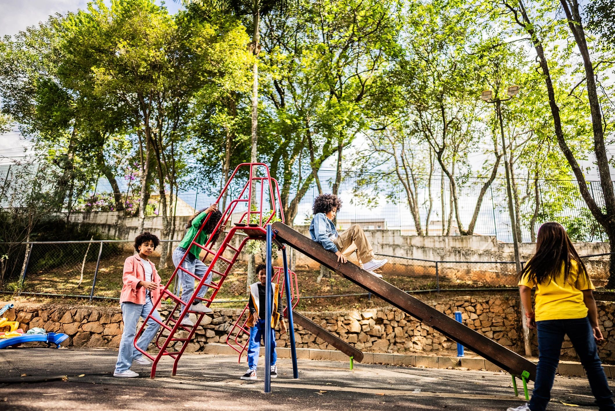 Students playing on a playground slide