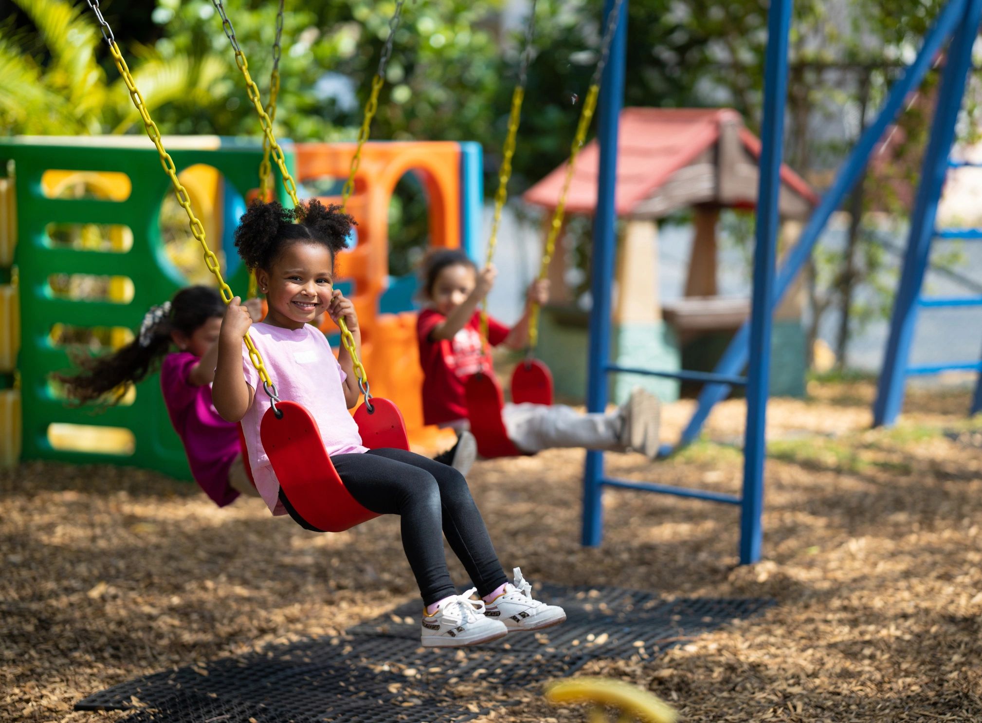Child playing on a playground swing