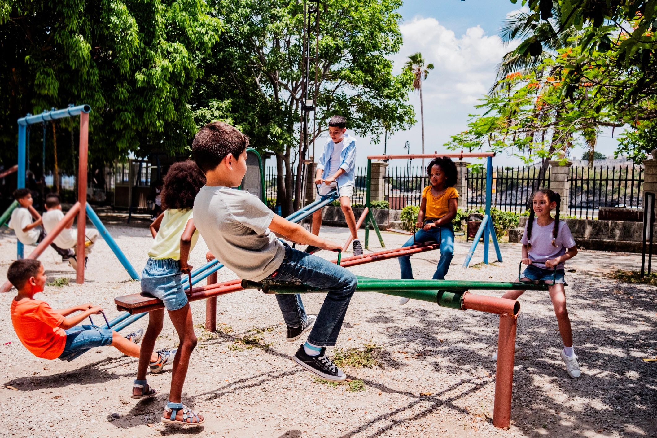 Children playing on a seesaw at a park
