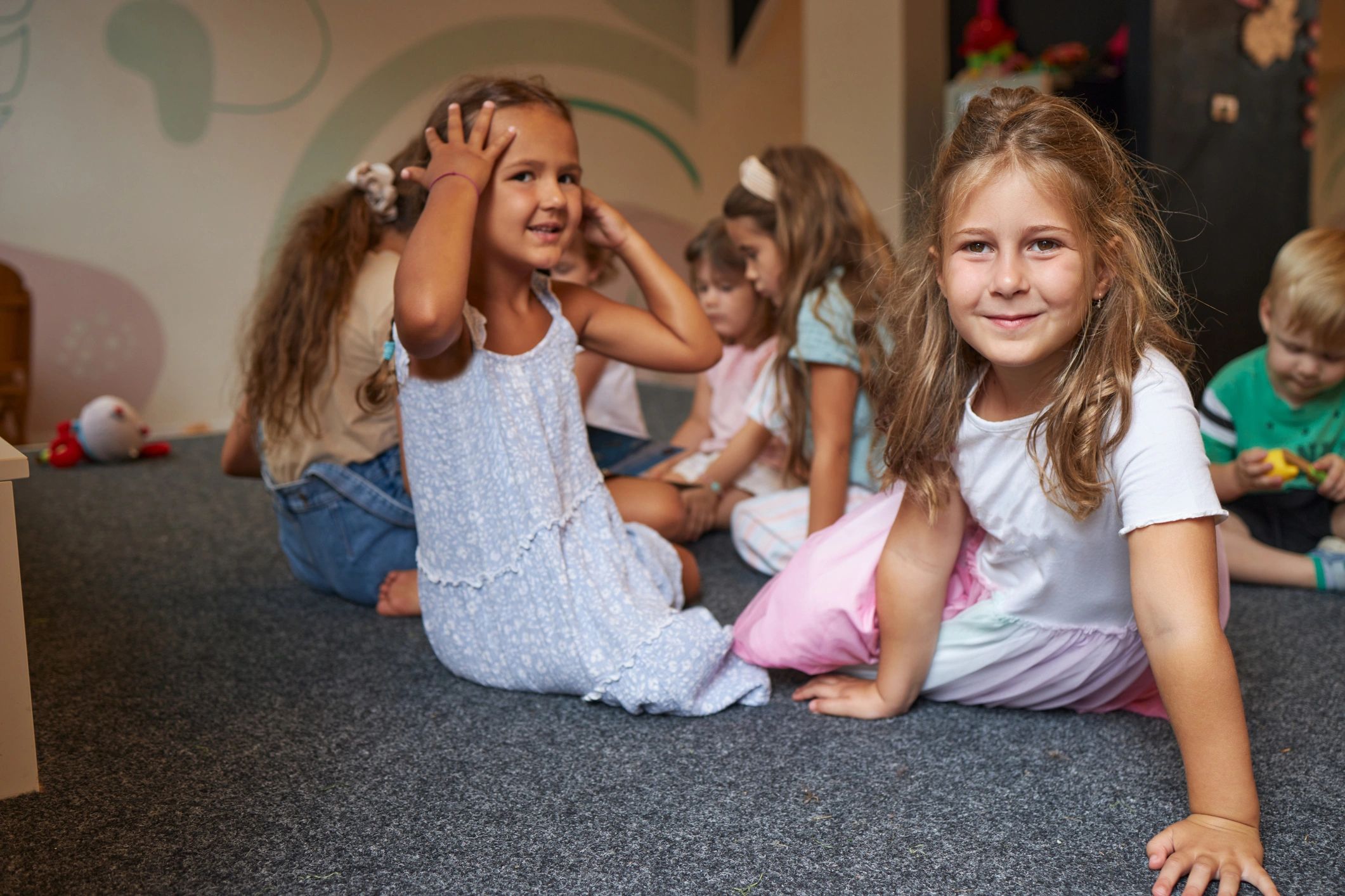 Children playing together on the floor in a bright playroom